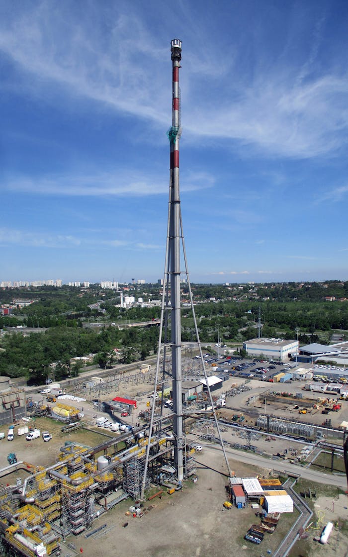 services-01 Aerial view of a tall refinery tower in an industrial area of Lyon, France.