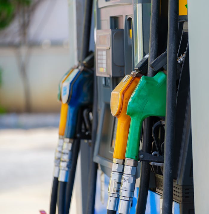 why-choose-us Close-up of vibrant fuel nozzles at a gasoline station showcasing diesel, gas, and petrol options.