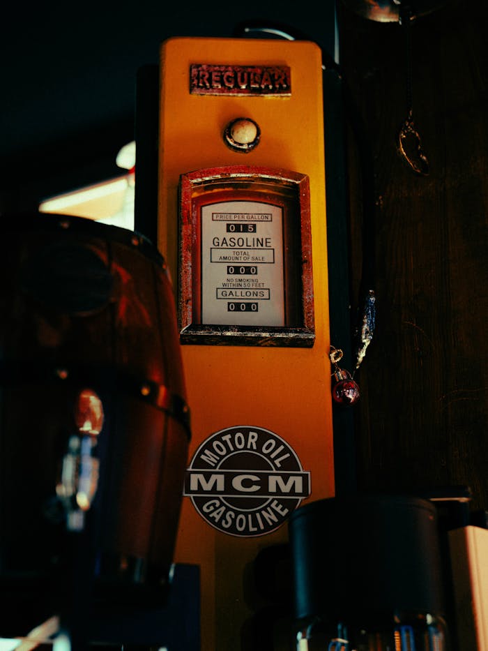 ours-journey Close-up of a vintage gasoline dispenser at night with retro design and bright colors.
