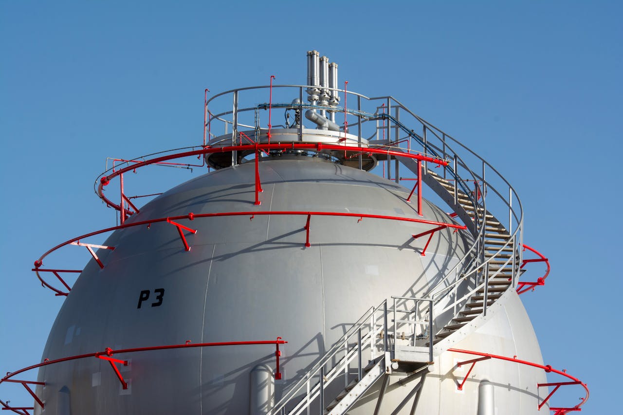 gallery-2 Close-up view of a large industrial gas storage sphere with a surrounding metal staircase.