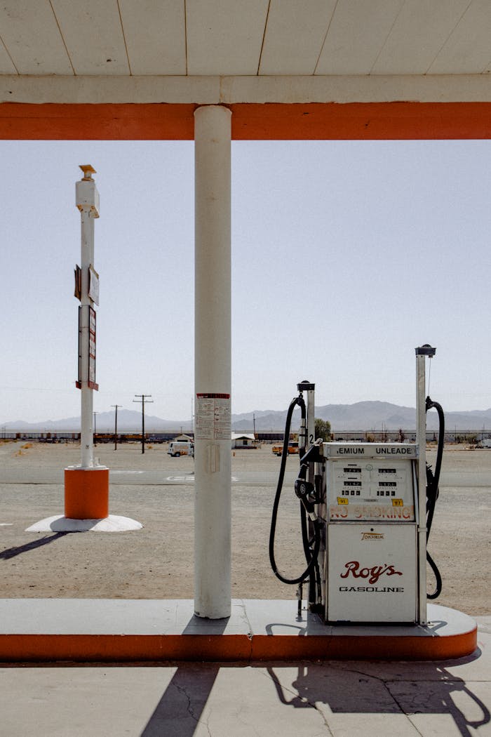 our-services-2 Classic gas station pump with a retro charm in a desert setting under bright daylight.