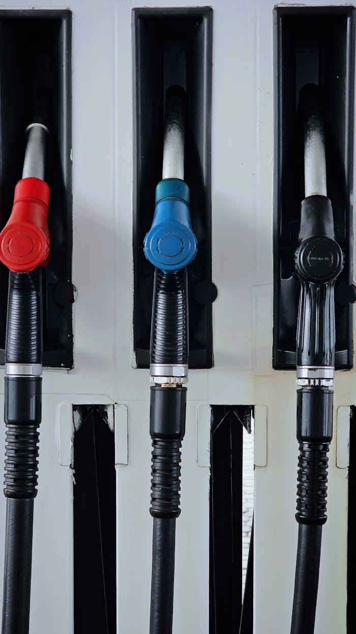 our-experience Close-up of multicolored fuel pumps at a gas station, showcasing different types of fuel.
